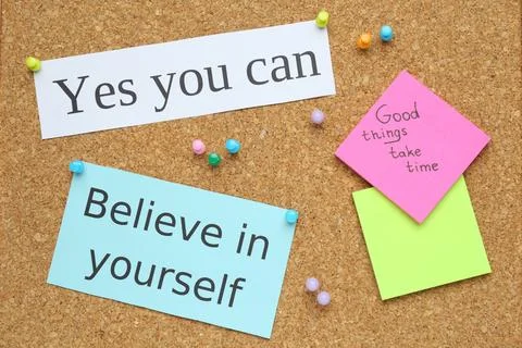 Notes with motivational quotes pinned to cork board, flat lay Stock Photos