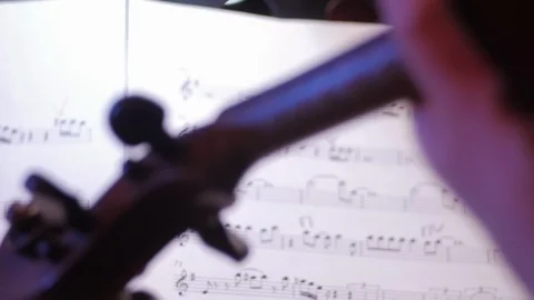 Notes on paper, the hand of a man who plays the violin at a concert Stock Footage 111517982