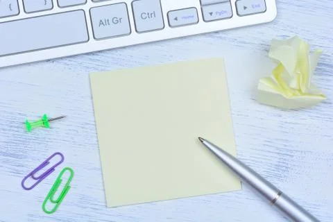 Notes with pen and computer keyboard on desk Stock Photos