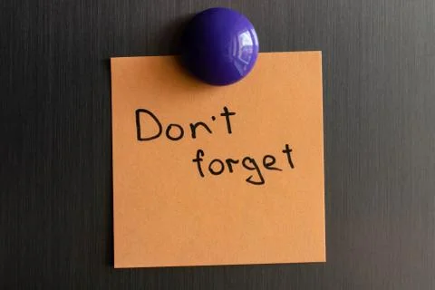 Notes with the words dont forget on the doors of the refrigerator. Stock Photos