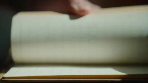 Noteworthy Moment: Hand Flipping Through a Notebook with Handwritten Content Stock Footage 322716080