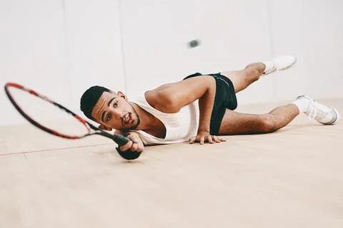 Nothing puts you through your paces like squash. Shot of a young man playing a Stock Photos