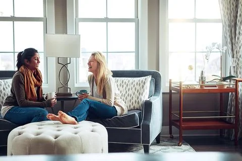 Nothing she values more than a visit from her friend. two young women having Foto stock