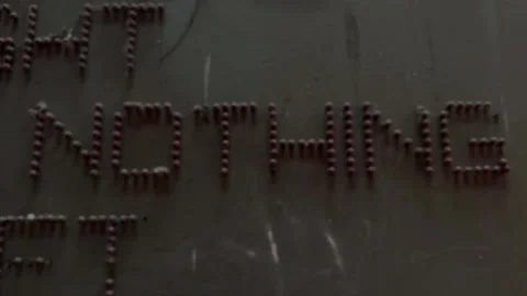 “NOTHING” text made of red bulbs blurs out on textured industrial wall Stockbeeldmateriaal 310017651