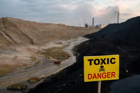 Notice on rectangular yellow board announcing about toxic and dangerous area Stock Photos