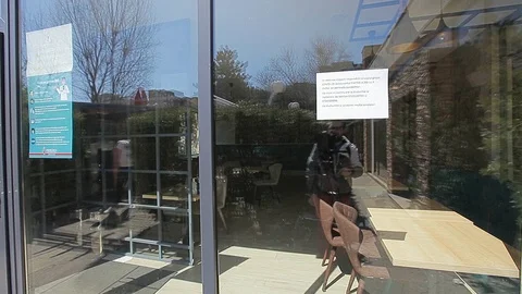 Notice In A Restaurant Window Which Reads Closed During The Pandemic Enforced Stock Footage 128428280