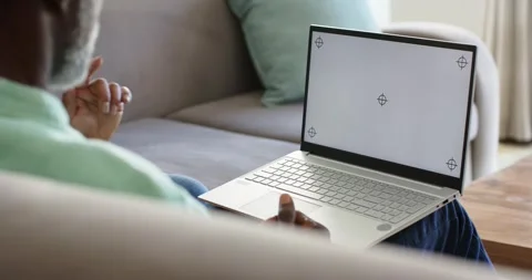 Noticing blank screen, senior man is pointing, hovering near laptop on lap, Stock Footage 338435288
