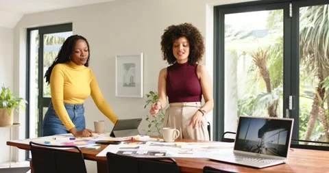 Noticing layout drafts on table, diverse coworkers picking up prints and tapping Stock-Footage 341736321