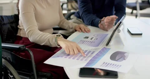 Noticing variation, Diverse coworkers comparing printouts and tablet aligning Stock Footage 317638472