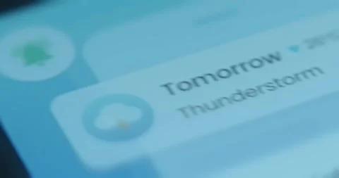 Notification message on smartphone shows a thunderstorm for tomorrow Stock Footage 323386893