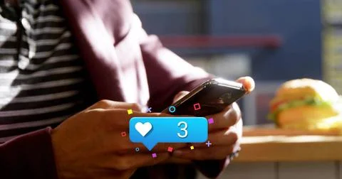 Notification popping, maroon jacket man tapping phone and checking heart alert Stock Photos