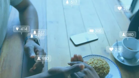 Notifications appearing and sparking couple clasping hands at cafe table, phone Stock Footage 333575043