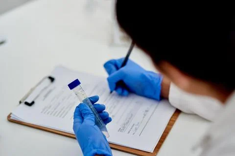Noting down the correct quantities for her tests. Closeup shot of an Stock Photos