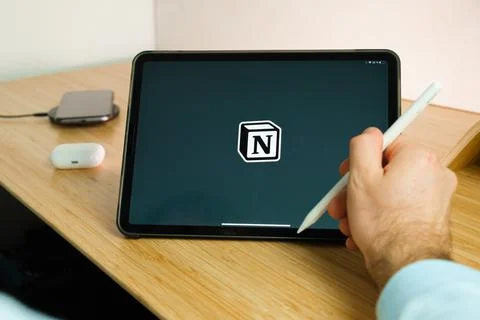 Notion is used with apple pencil on iPad Pro tablet . Man using application on Stock Photos