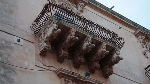 Noto sicily italy statue work of horses beneath underneath balcony with tilt Stock Footage 252155549