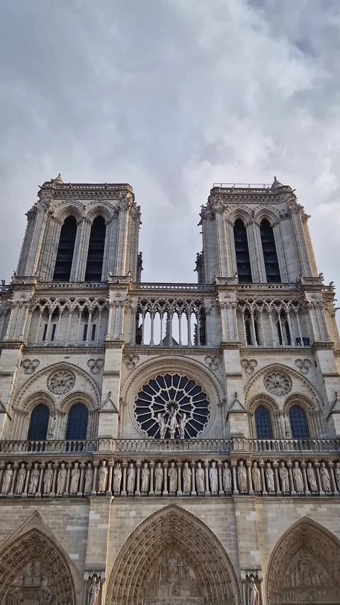 The Notre-Dame Cathedral facade in Paris, France, highlighting the intricate por Stock Footage 325081146