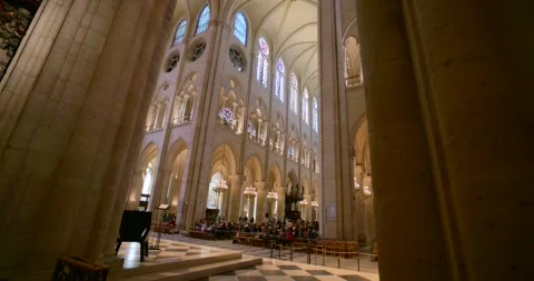 Notre Dame cathedral interior, people gather inside beautiful hall for mass Stock Footage 321735480