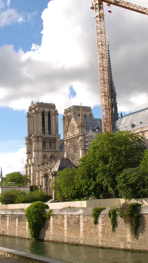 Notre Dame Cathedral Renovation with Construction Cranes and Seine River Stock Footage 344089519