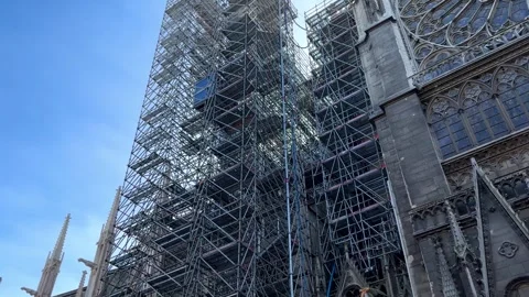 Notre Dame de Paris Cathedral with scaffolding and lift moving down Stock Footage 331529320