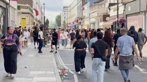 Notting Hill Carnival dense crowds on busy London street Stock Footage 344399228