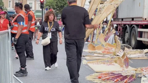 Notting Hill Carnival workers handling decorative parade structures Stock Footage 344399239