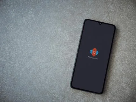 Nova Launcher app launch screen with logo on the display of a black mobile sm Stock Photos