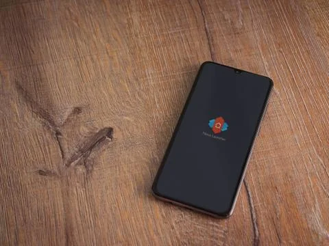 Nova Launcher app launch screen with logo on the display of a black mobile sm Stock Photos