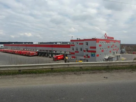 Nova Poshta logistics warehouse building with loading docks and docked red Stock Photos