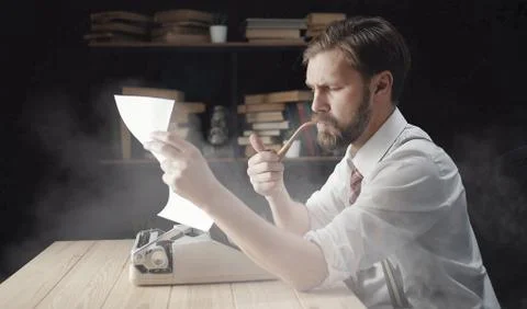 Novelist looking at typescript Stock Photos