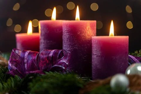  November 24, 2023: Advent season themed picture, four purple candles burn... Stock Photos