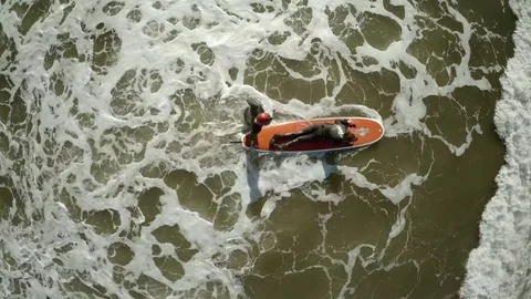 Novice Surfer and Trainer Enter Ocean Stock Footage 78013718