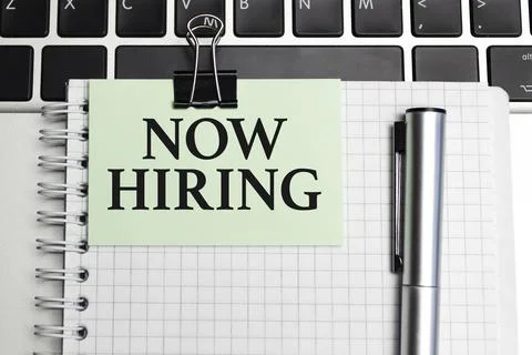 Now Hiring text and notepad with pen, charts and calculator Stock-Fotos