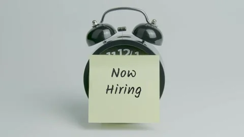Now Hiring Text or Word on Yellow Note Paper Sticking onto Black Alarm Clock Stock Footage 299930730