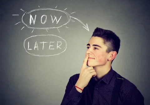 Now or later. Man thinking making up his mind Stock Photos
