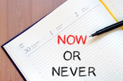 Now or never write on notebook Stock Photos