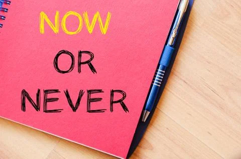 Now or never write on notebook Stock Photos