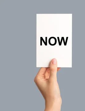 NOW reminder to do, memo note in hand Stock Photos