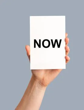 NOW reminder to do, memo note card in hand Stock Photos