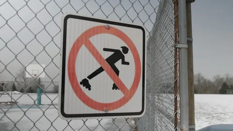 Now roller blading sign on chain link fence Stock-Footage 104310501