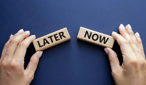 Now vs Later symbol. Concept word Now vs Later on wooden blocks. Businessma.. Stockfoto's