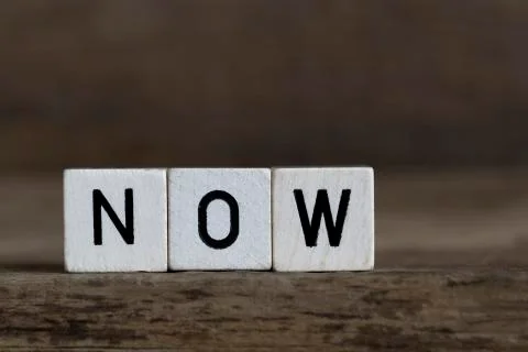 Now, written in cubes Stock Photos