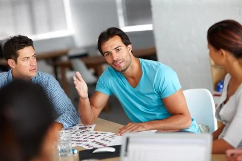 Now youre getting it. A group of businesspeople discussing work. Stock Photos
