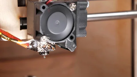 The nozzle of the printer is ready for printing. The plastic begins to come out Stock Footage 77947898