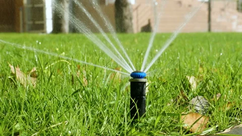 Nozzle for spraying water by automatic watering system for lawn. 4K Stock Footage 107644086