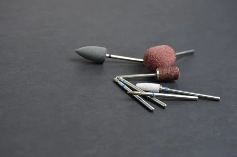 Nozzles for a manicure machine. Grey background. Stock Photos