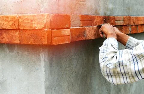 Nstalling bricks on wall workers of hands construction site Stock Photos