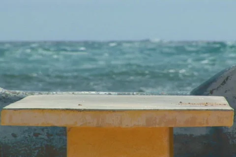 NTSC: Concrete bench at the ocean Stock Footage 153547