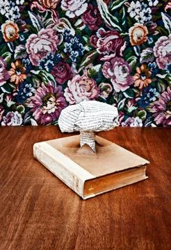 Nuclear cloud made out of printed paper coming out of book Stock Photos