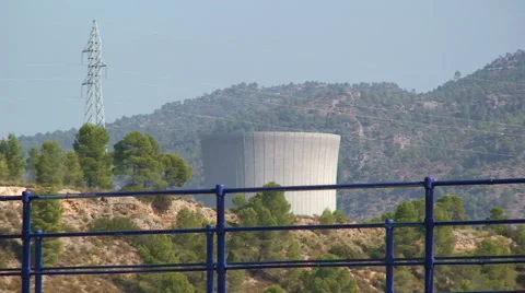 Nuclear cooling tower behind a bridge, transmission tower Stock Footage 49964778