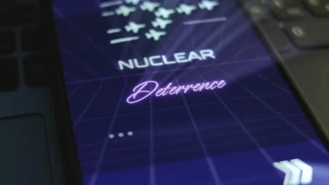 Nuclear Deterrence inscription on smartphone screen with dark blue background Stock Footage 270962915